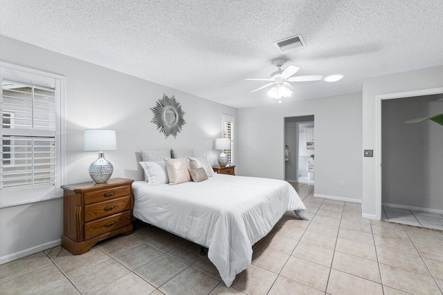 bedroom featuring light tile patterned floors, a textured ceiling, and ceiling fan