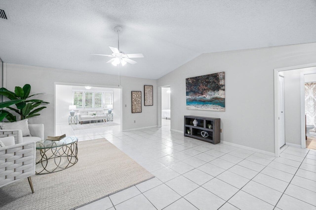 tiled living room featuring a textured ceiling, vaulted ceiling, and ceiling fan