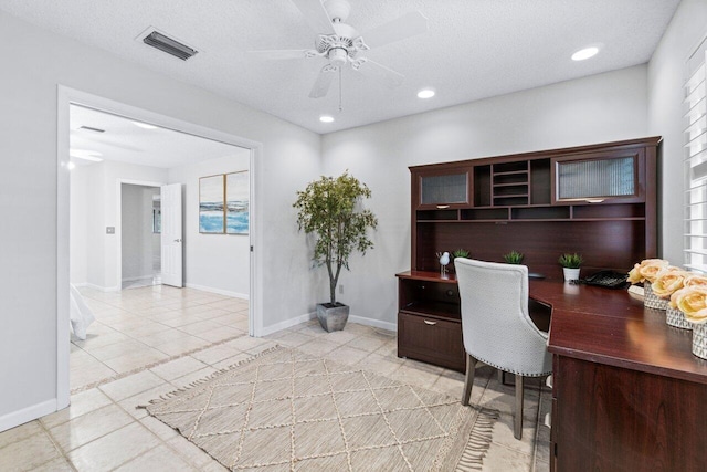 home office with ceiling fan, light tile patterned floors, and a textured ceiling