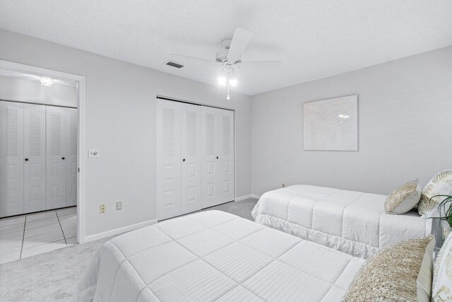 carpeted bedroom with a textured ceiling, a closet, and ceiling fan