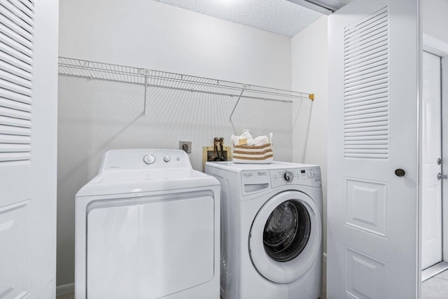 laundry area featuring independent washer and dryer and a textured ceiling