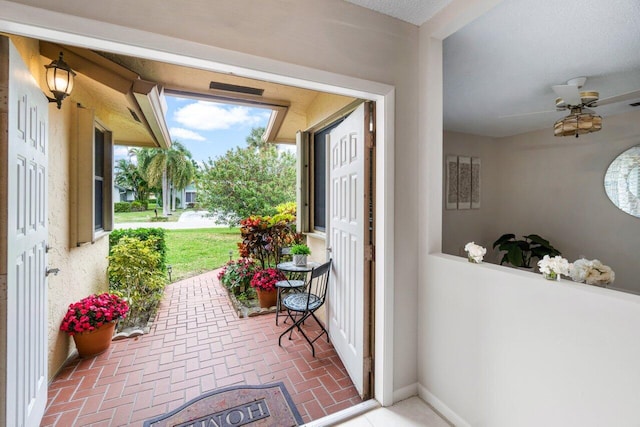 doorway to outside featuring ceiling fan