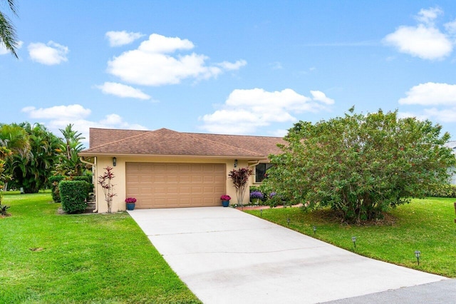 view of front of home with a front yard and a garage