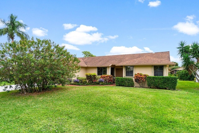 ranch-style home featuring a front lawn