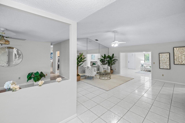 tiled living room with ceiling fan, lofted ceiling, and a textured ceiling