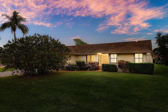 ranch-style house with a lawn