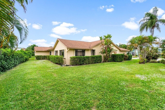 view of side of home featuring a yard