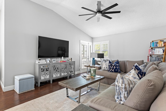 living room with a textured ceiling, lofted ceiling, ceiling fan, and dark hardwood / wood-style floors