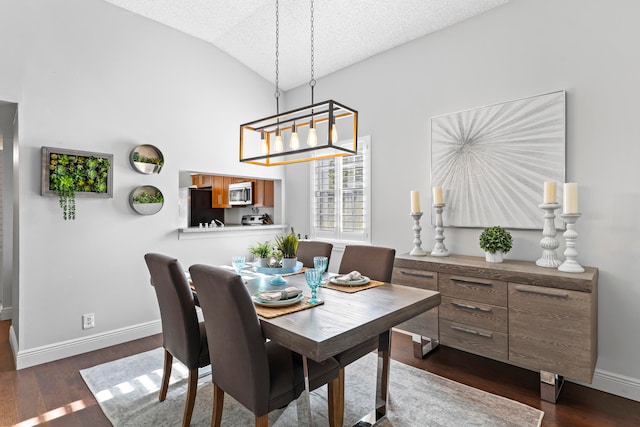 dining room with a textured ceiling, dark hardwood / wood-style flooring, and lofted ceiling