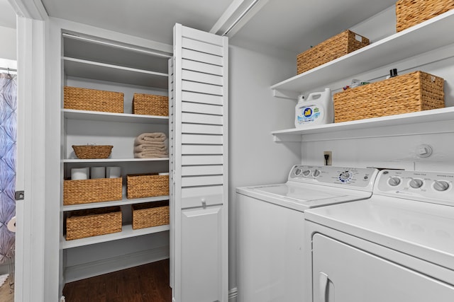 laundry room with separate washer and dryer and hardwood / wood-style flooring