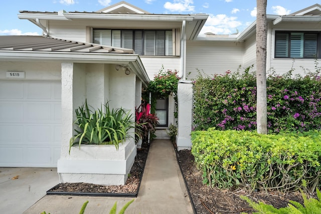 view of exterior entry with a garage