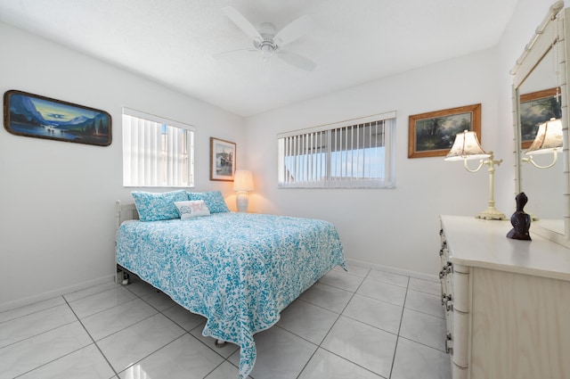 bedroom with ceiling fan and light tile patterned floors