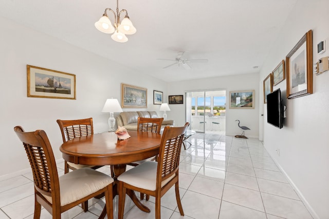 dining space featuring ceiling fan with notable chandelier and light tile patterned flooring