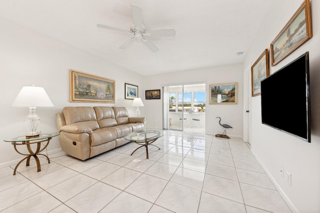 tiled living room with ceiling fan