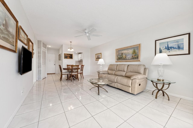 tiled living room with ceiling fan