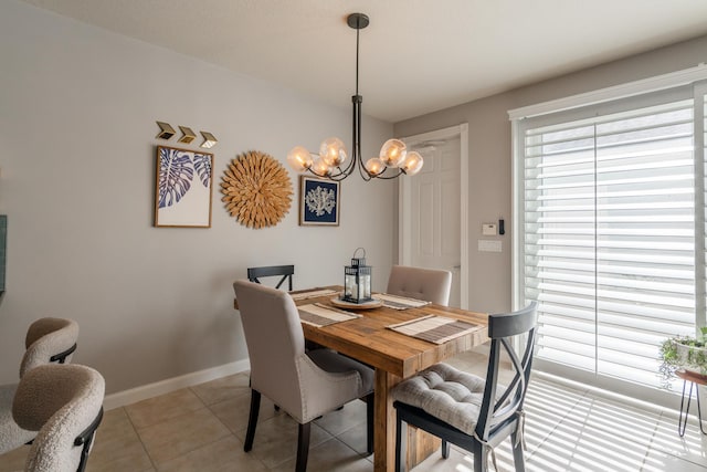 dining space with a chandelier and light tile patterned floors