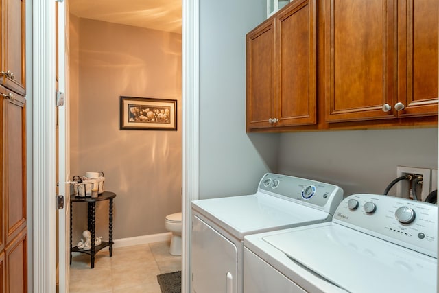 laundry area with separate washer and dryer and light tile patterned floors