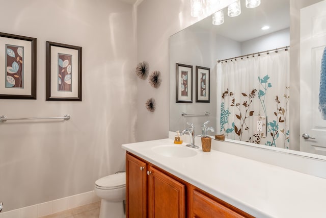 bathroom with tile patterned flooring, vanity, toilet, and walk in shower