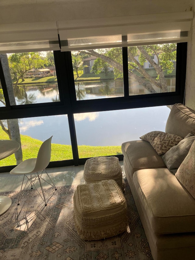 sunroom featuring a water view and a wealth of natural light