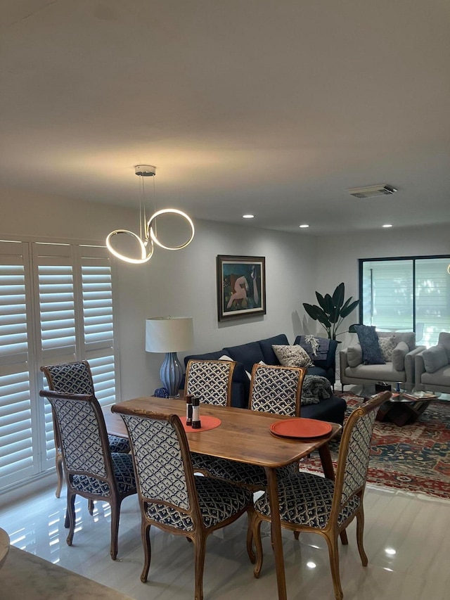 dining room featuring a notable chandelier and light wood-type flooring