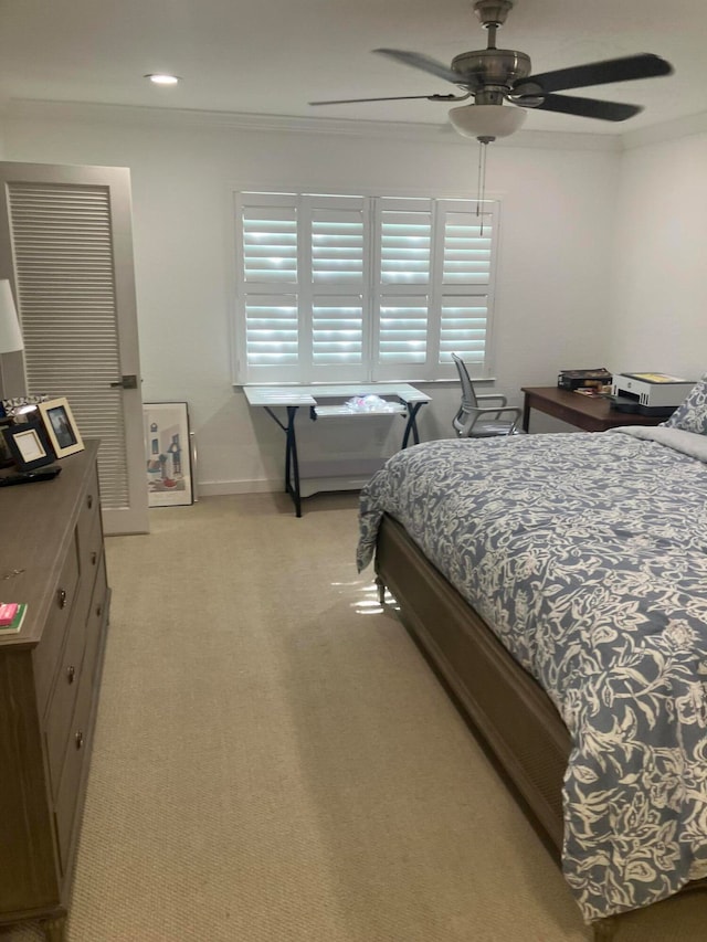 bedroom featuring light carpet and ceiling fan