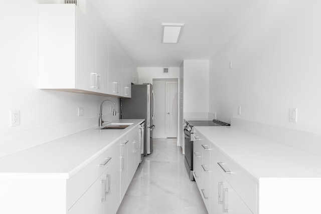 kitchen with white cabinetry, appliances with stainless steel finishes, and sink