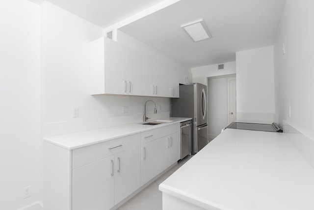 kitchen featuring white cabinetry, appliances with stainless steel finishes, and sink