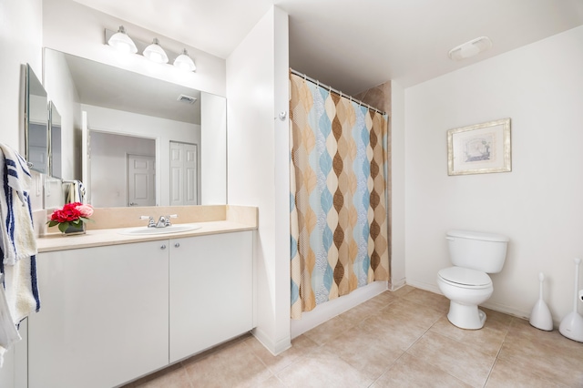 bathroom featuring tile patterned floors, vanity, and toilet