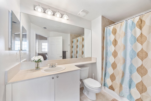 bathroom with tile patterned flooring, vanity, curtained shower, and toilet