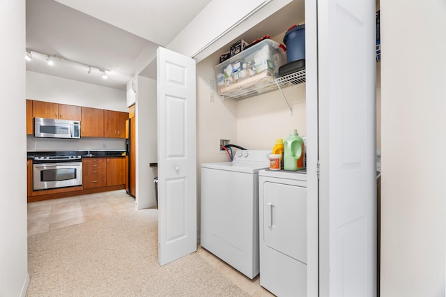 washroom with washing machine and dryer and light tile patterned floors