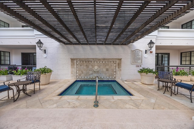 view of swimming pool featuring a community hot tub, a pergola, and a patio area