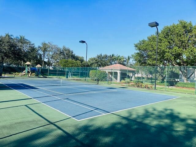 view of tennis court featuring basketball hoop