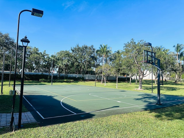 view of basketball court with a lawn