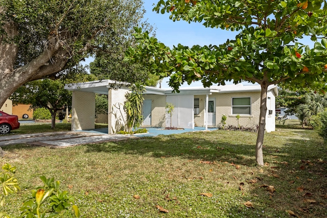 single story home featuring a front lawn and a carport