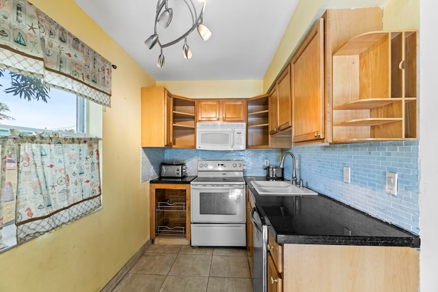 kitchen featuring light tile patterned floors, white appliances, tasteful backsplash, and sink