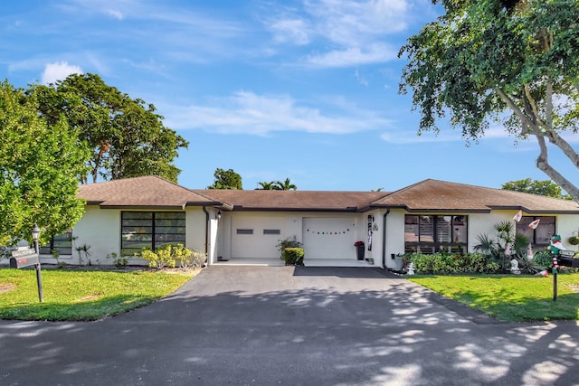 single story home featuring a front yard and a garage