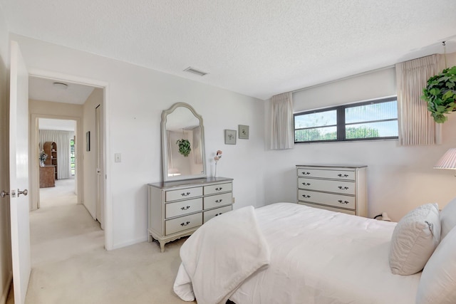 carpeted bedroom featuring a textured ceiling