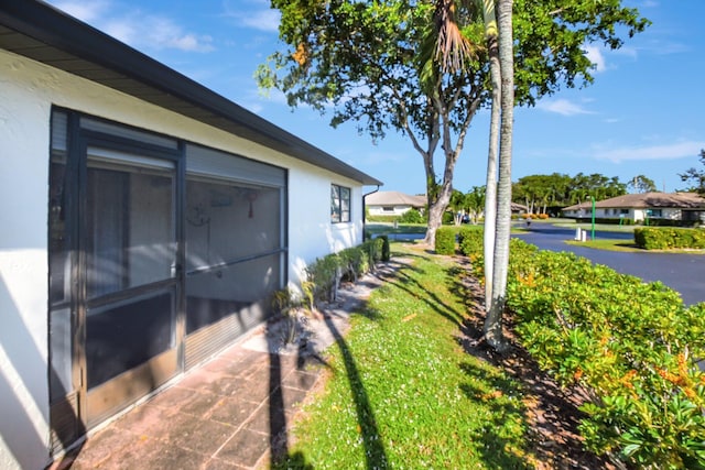 view of side of home with a lawn