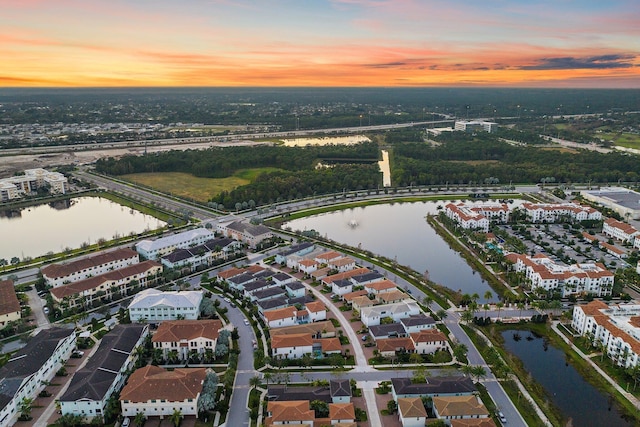 aerial view at dusk with a water view