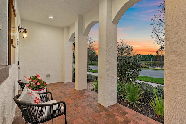 patio terrace at dusk with a water view