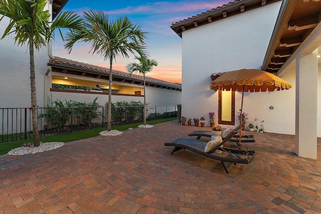 view of patio terrace at dusk