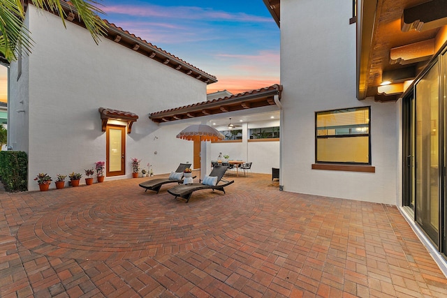 view of patio terrace at dusk