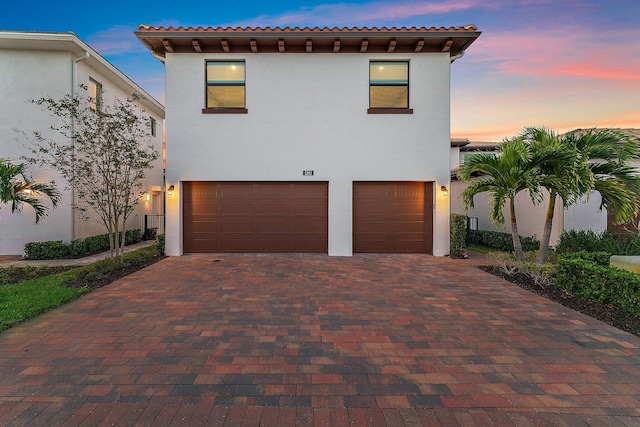 mediterranean / spanish home featuring a garage