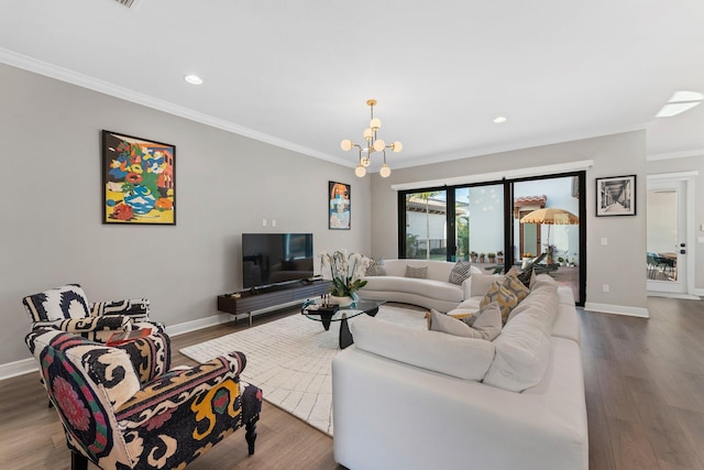 living room with a chandelier, hardwood / wood-style flooring, and crown molding