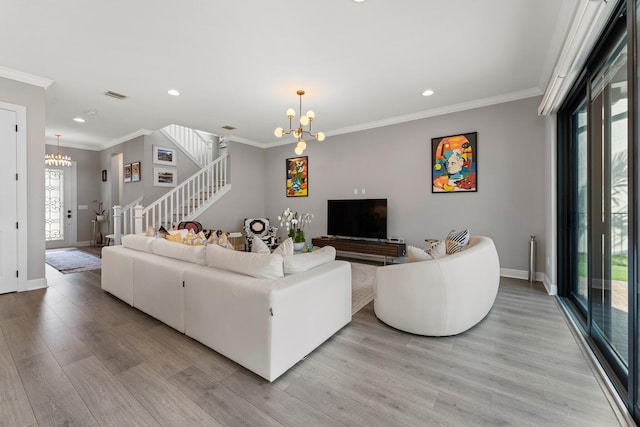 living room featuring light hardwood / wood-style floors, an inviting chandelier, and ornamental molding