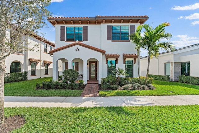 mediterranean / spanish-style home with a front lawn