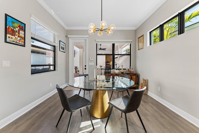 dining space featuring hardwood / wood-style floors, crown molding, and a wealth of natural light