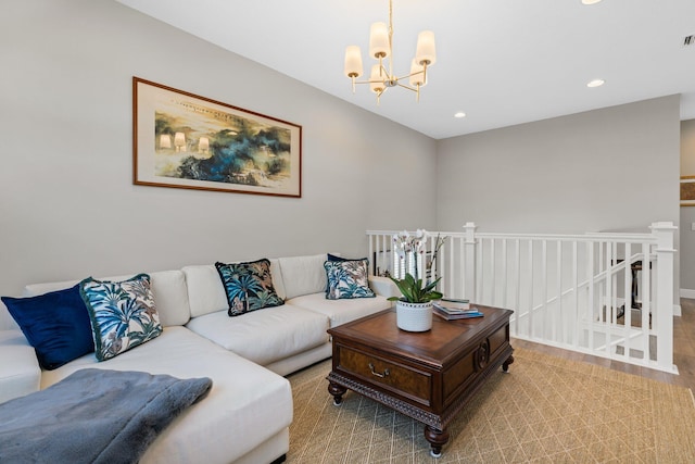 living room with a chandelier and light hardwood / wood-style flooring