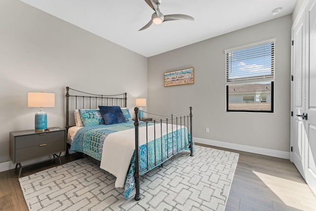 bedroom with ceiling fan and light hardwood / wood-style floors