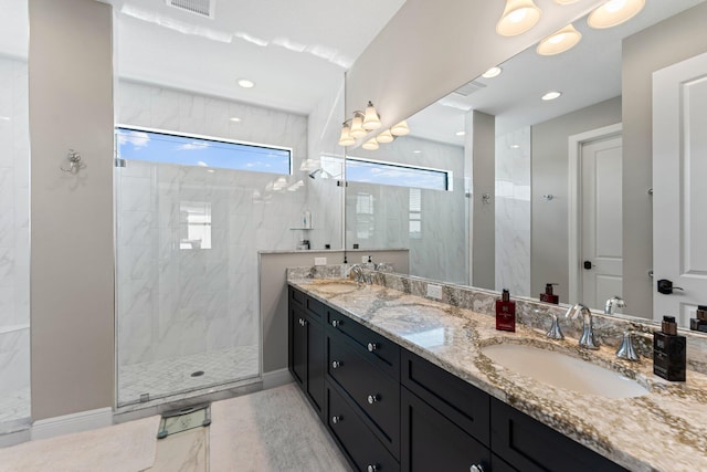 bathroom featuring a tile shower and vanity